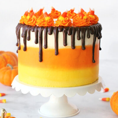 Candy corn cake decorated to look like a candy corn made with chocolate cake.