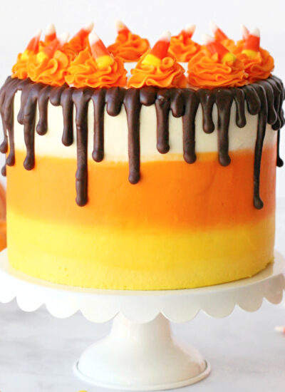 Candy corn cake decorated to look like a candy corn made with chocolate cake.