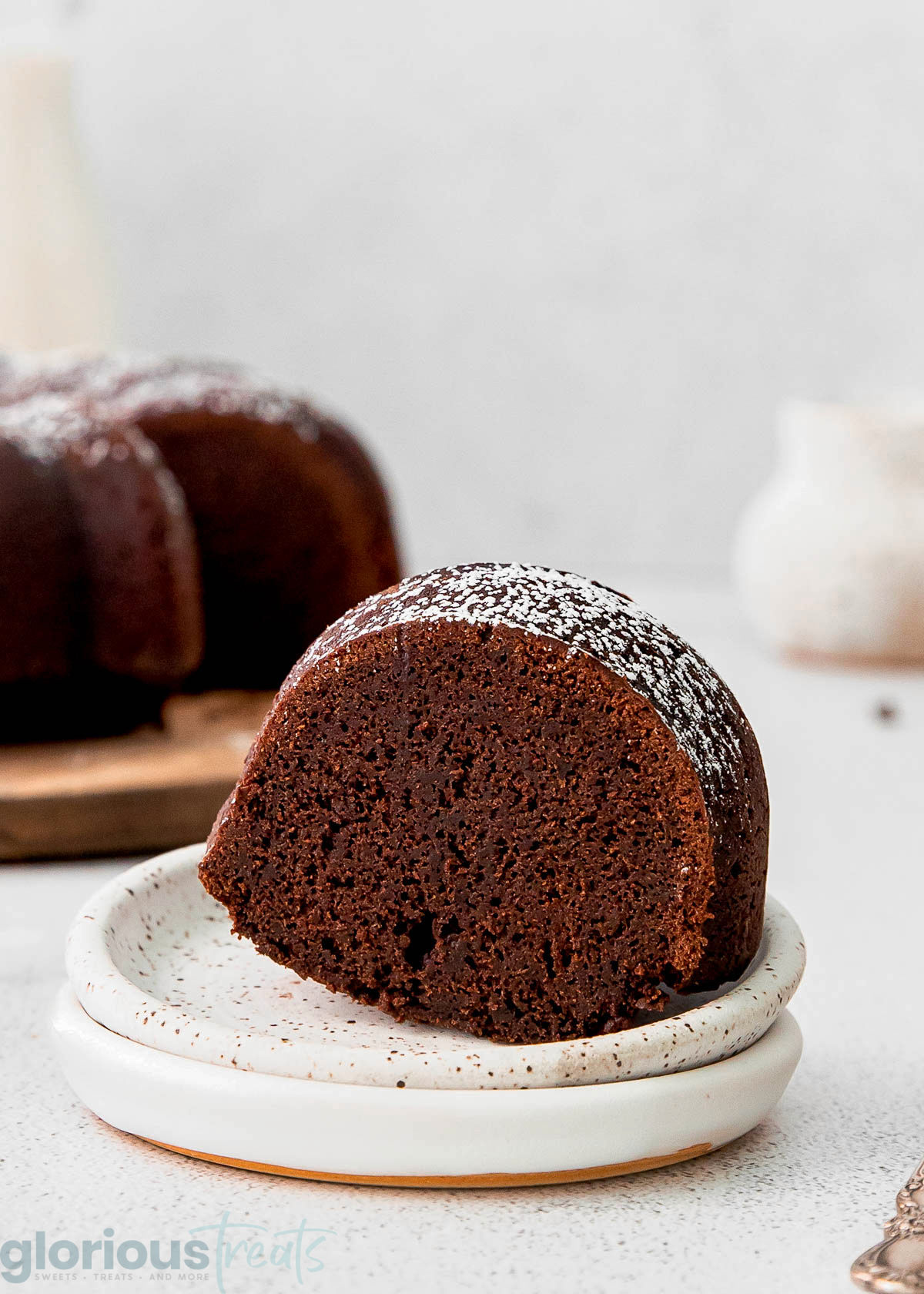 a piece of chocolate bundt cake on a white plate.