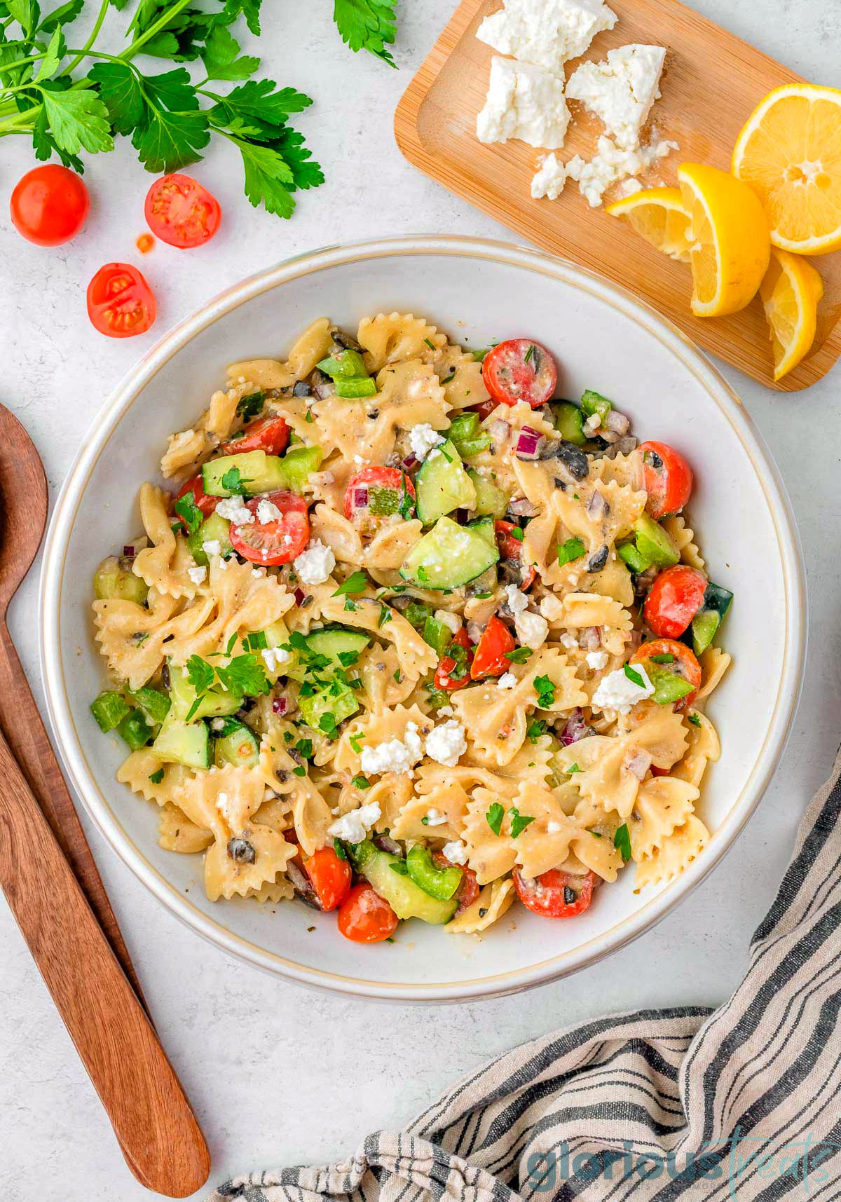 A top down shot of Greek Pasta Salad in a white bowl.