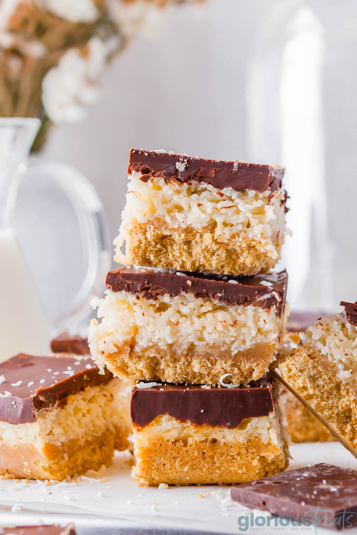 Chocolate coconut bars stacked on top of each other.