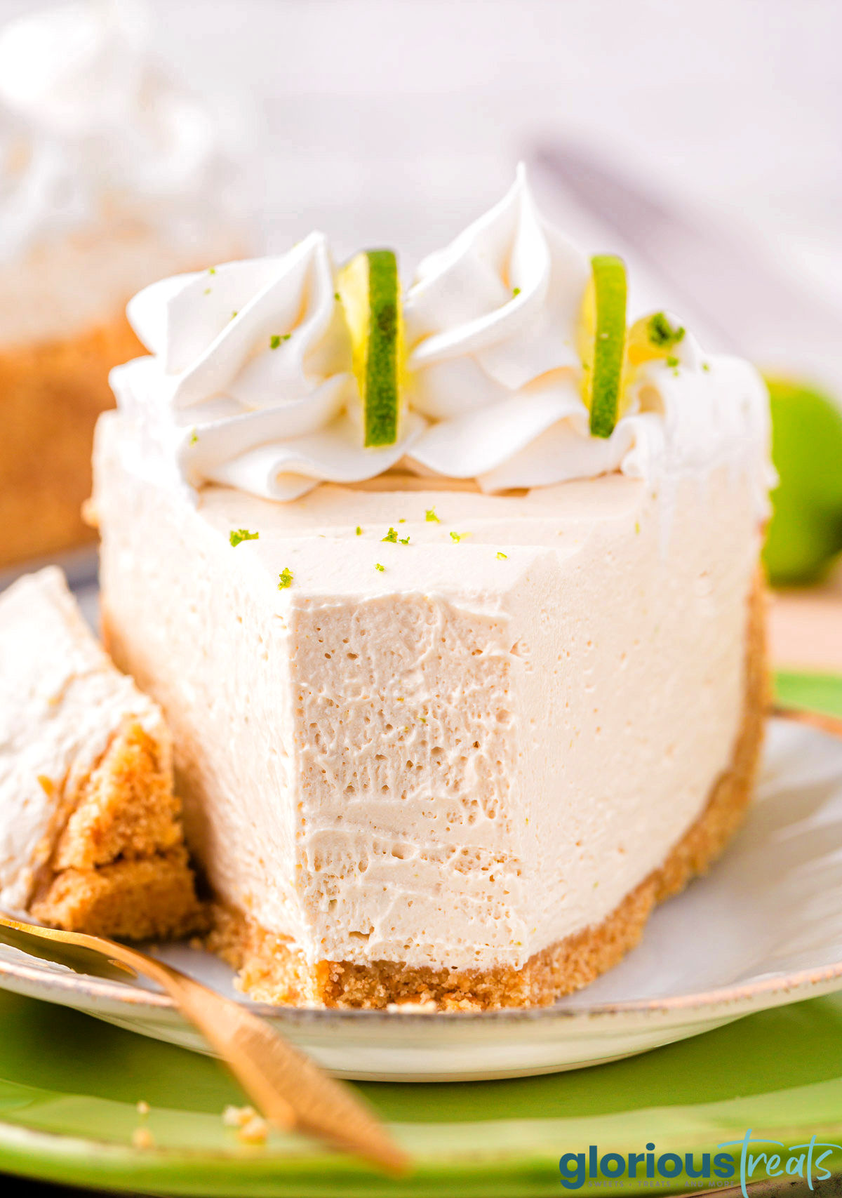 A slice of key lime cheesecake with a bite taken out of it.