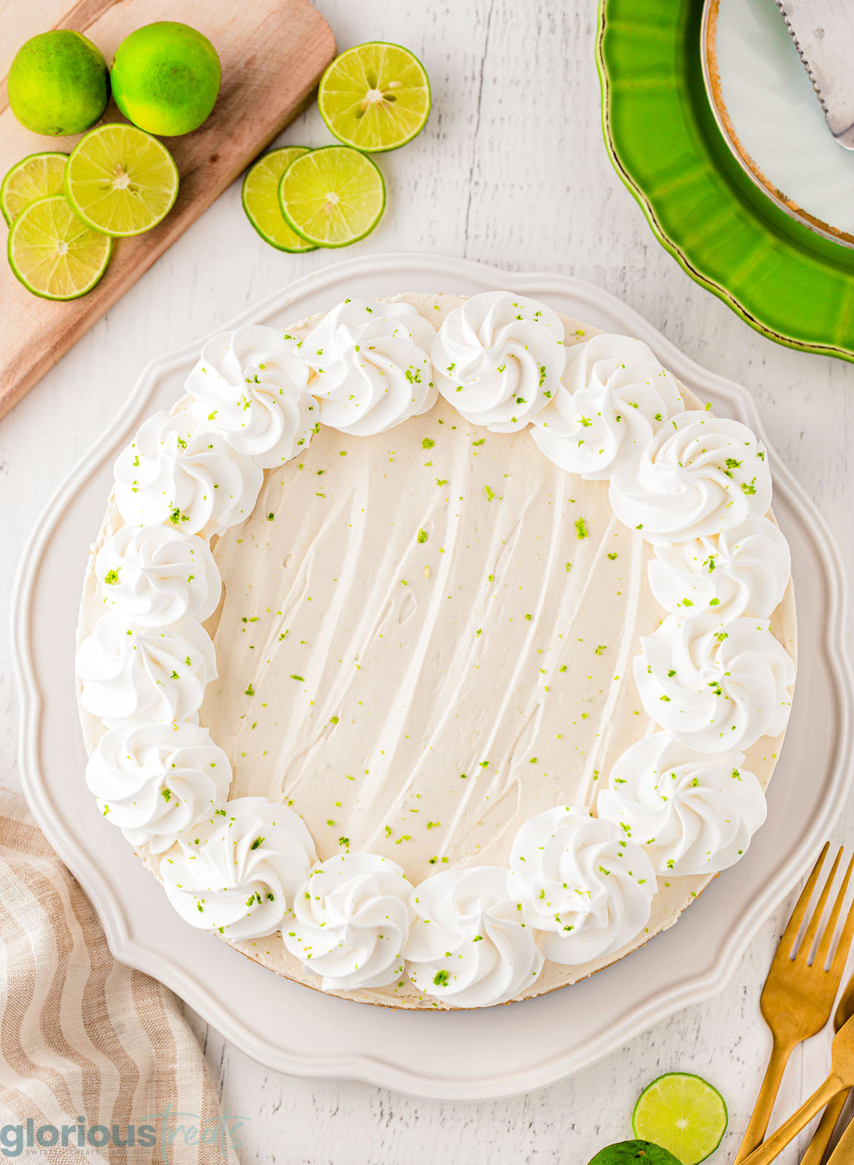 A top down shot of key lime cheesecake on a white plate.