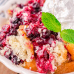 Close up shot of berry cobbler on a white plate.