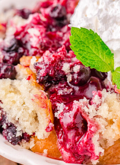 Close up shot of berry cobbler on a white plate.