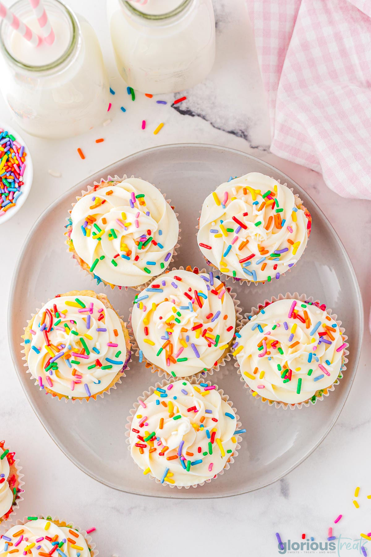 A top down shot of birthday cupcakes on a gray plate.