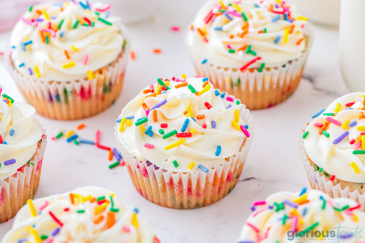 Birthday cupcakes on a white surface.