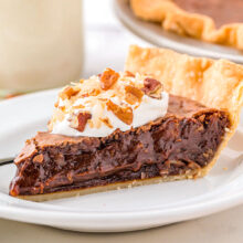 A slice of german chocolate pie on a white plate.