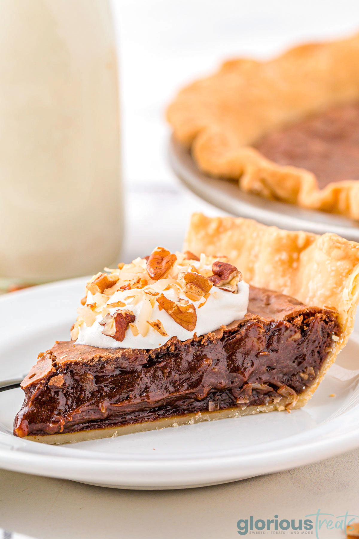 A slice of german chocolate pie on a white plate.