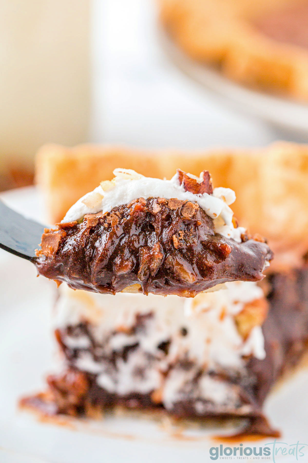 A forkful of German Chocolate Pie being held up in front of the slice of pie.