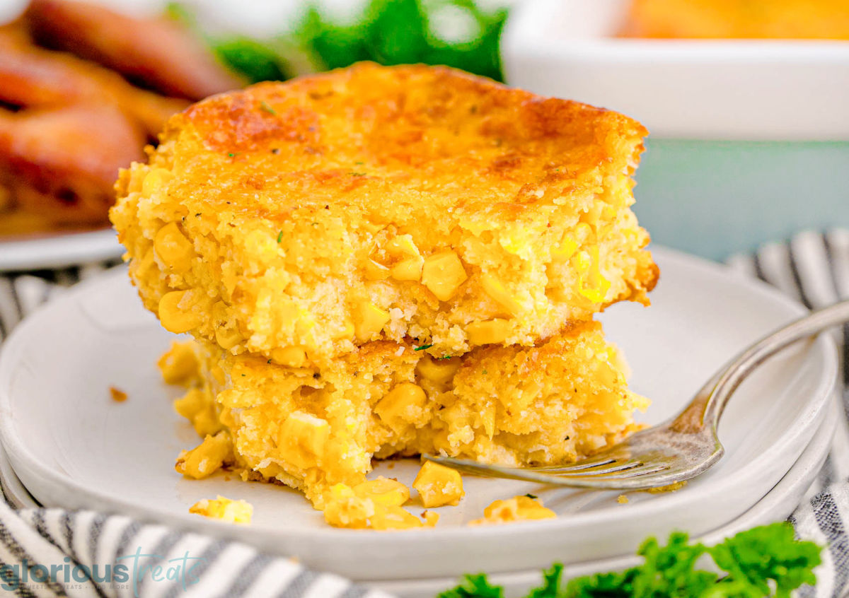 A piece of cornbread casserole on a white plate.