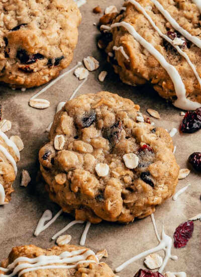 Cranberry Oatmeal Cookies laid out on a piece of brown parchment paper.