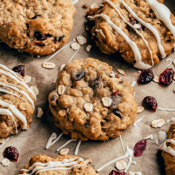 Cranberry Oatmeal Cookies laid out on a piece of brown parchment paper.