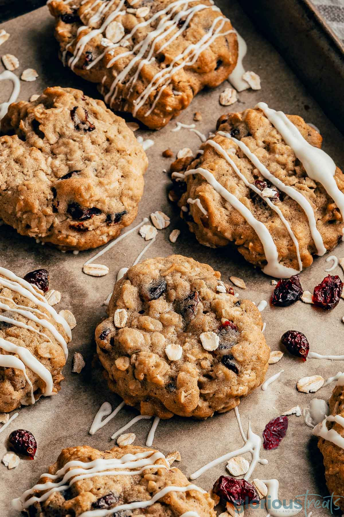 Cranberry Oatmeal Cookies laid out on a piece of brown parchment paper.